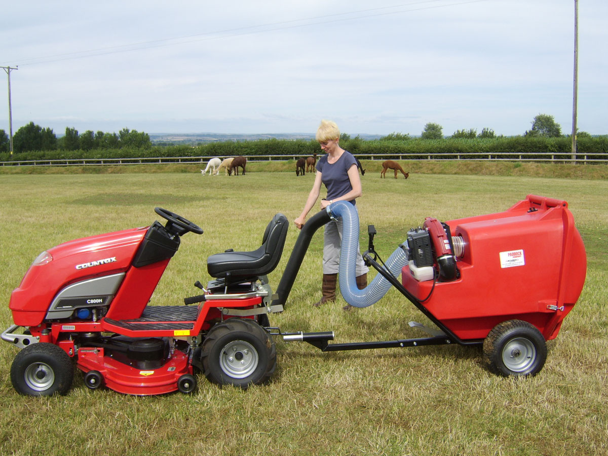 Field vacuums towed by a ride-on mower